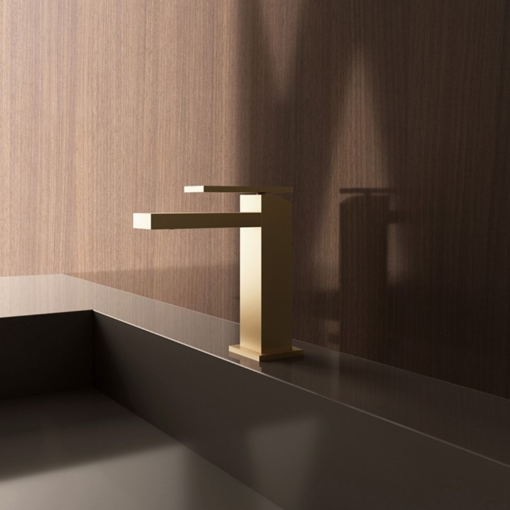Lifestyle image of the Crosswater Myron Brushed Brass Basin Mixer Tap mounted on a basin deck